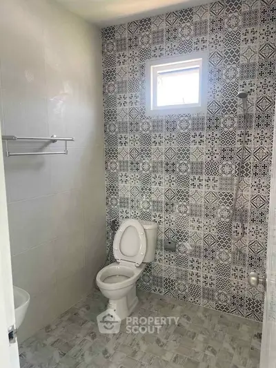 Modern bathroom with patterned tiles and window for natural light