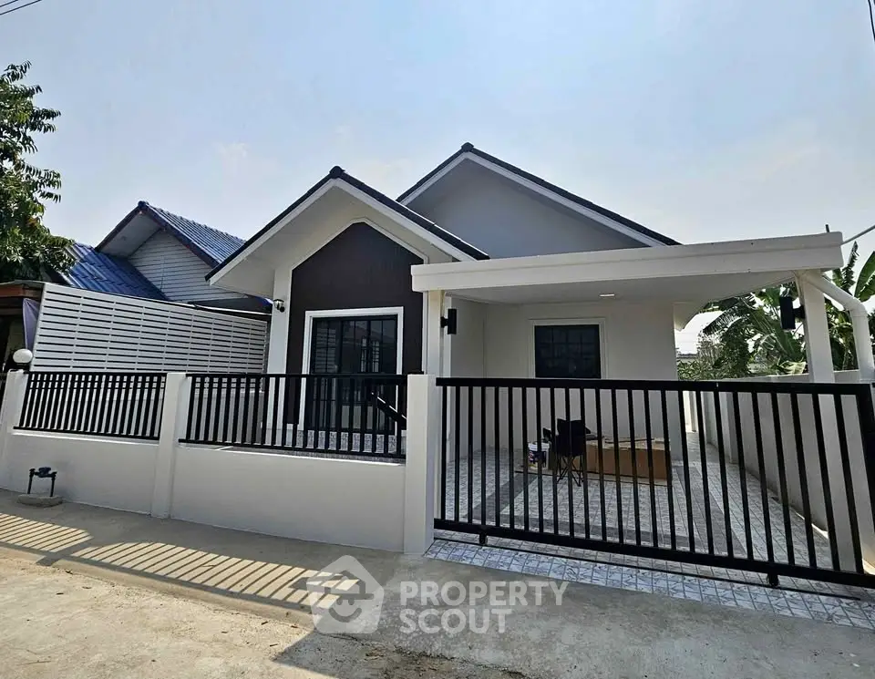 Charming single-story house with modern design and gated driveway in a serene neighborhood.