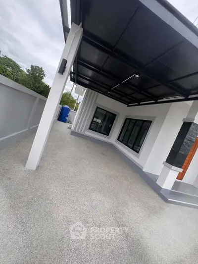 Modern home exterior with sleek design and spacious covered patio area.