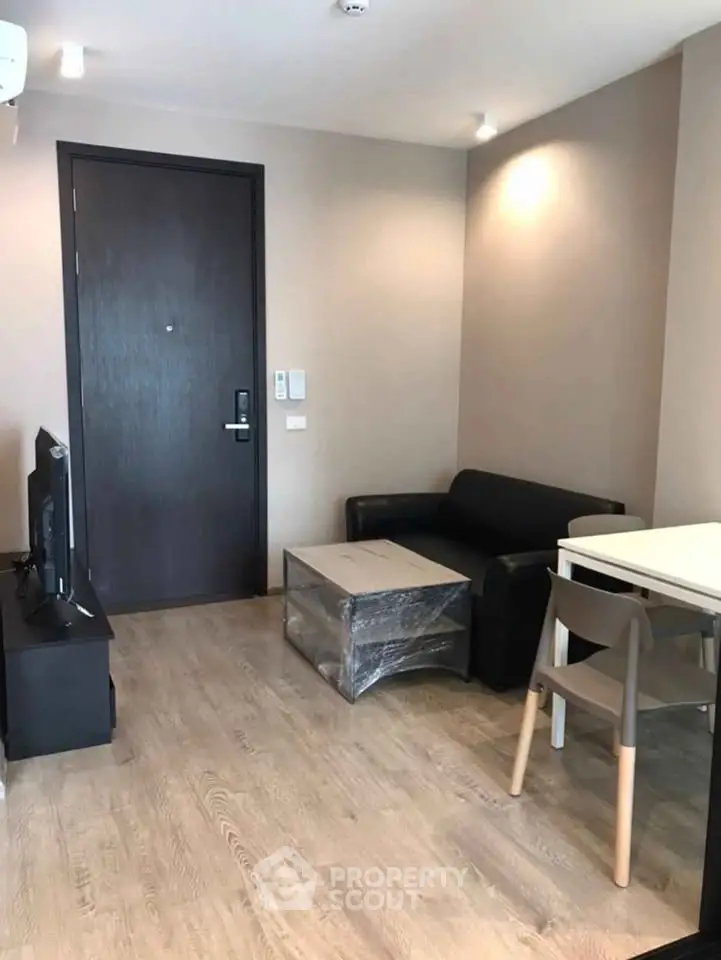 Cozy living room with modern furniture and wooden flooring in a stylish apartment.