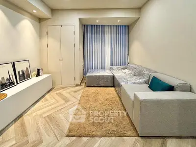 Modern living room with stylish decor and cozy seating area, perfect for relaxation.
