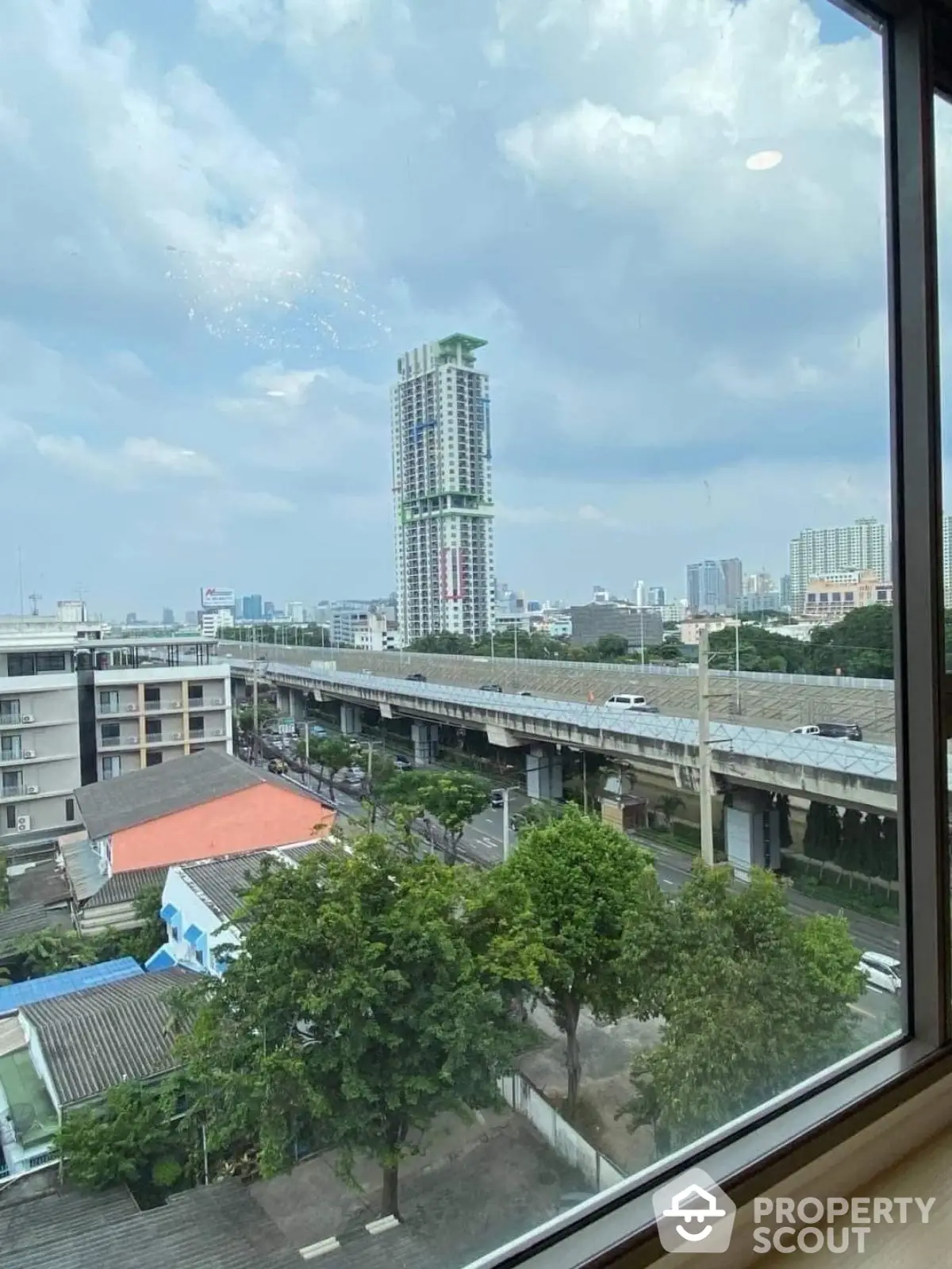 Stunning cityscape view from high-rise window showcasing urban skyline and modern architecture.