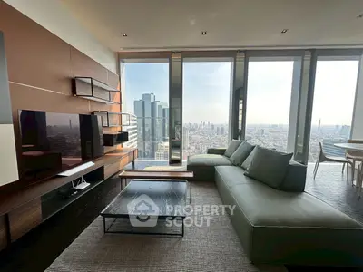 Luxurious living room with panoramic city view, modern furniture, and floor-to-ceiling windows in high-rise apartment.