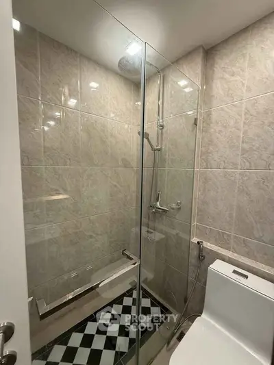 Modern bathroom with glass shower and tiled walls