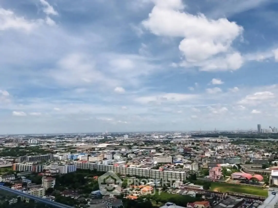 Stunning panoramic cityscape view from high-rise building showcasing urban landscape under blue skies.