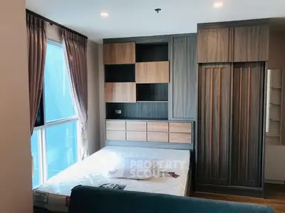 Modern bedroom with stylish wooden wardrobe and large window