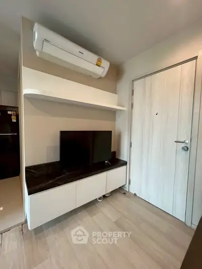 Modern living room with sleek TV unit and air conditioning