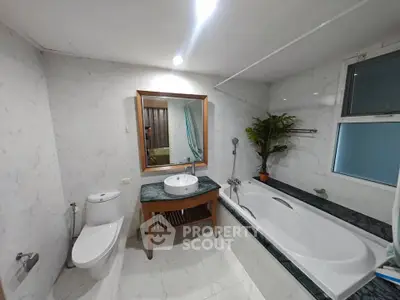 Luxurious bathroom with elegant bathtub and modern fixtures in a stylish real estate property.