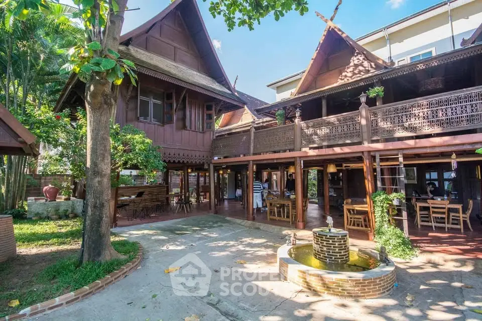 Charming traditional wooden house with spacious courtyard and fountain, perfect for serene living.