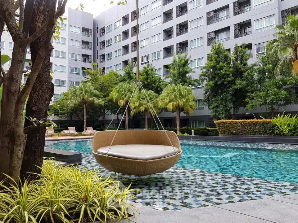 Luxurious apartment complex with modern pool and lush greenery, perfect for relaxation and leisure.