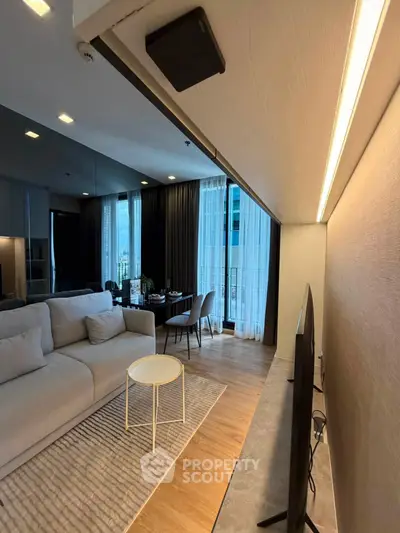 Modern living room with cozy sofa, stylish decor, and floor-to-ceiling windows in a chic apartment.