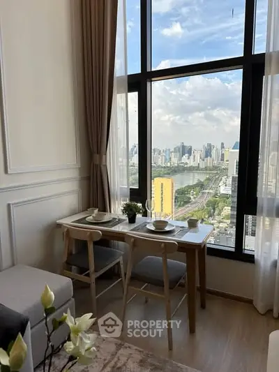 Chic dining area with stunning cityscape view through large window, perfect for urban living.