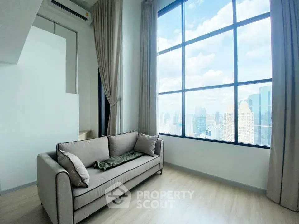 Stunning high-rise living room with panoramic city views and modern decor.