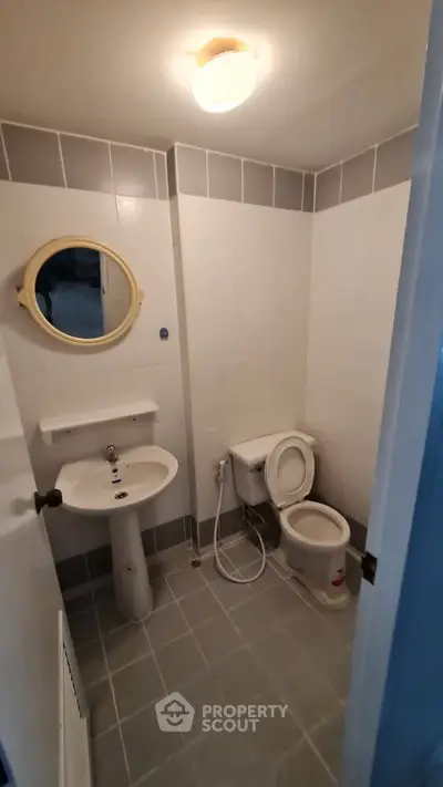 Compact bathroom with modern fixtures and neutral tile design