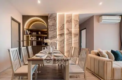 Modern dining area with elegant lighting and cozy seating in a stylish apartment.