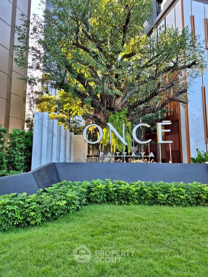 Luxurious building entrance with lush greenery and modern architecture at Once Pattaya.