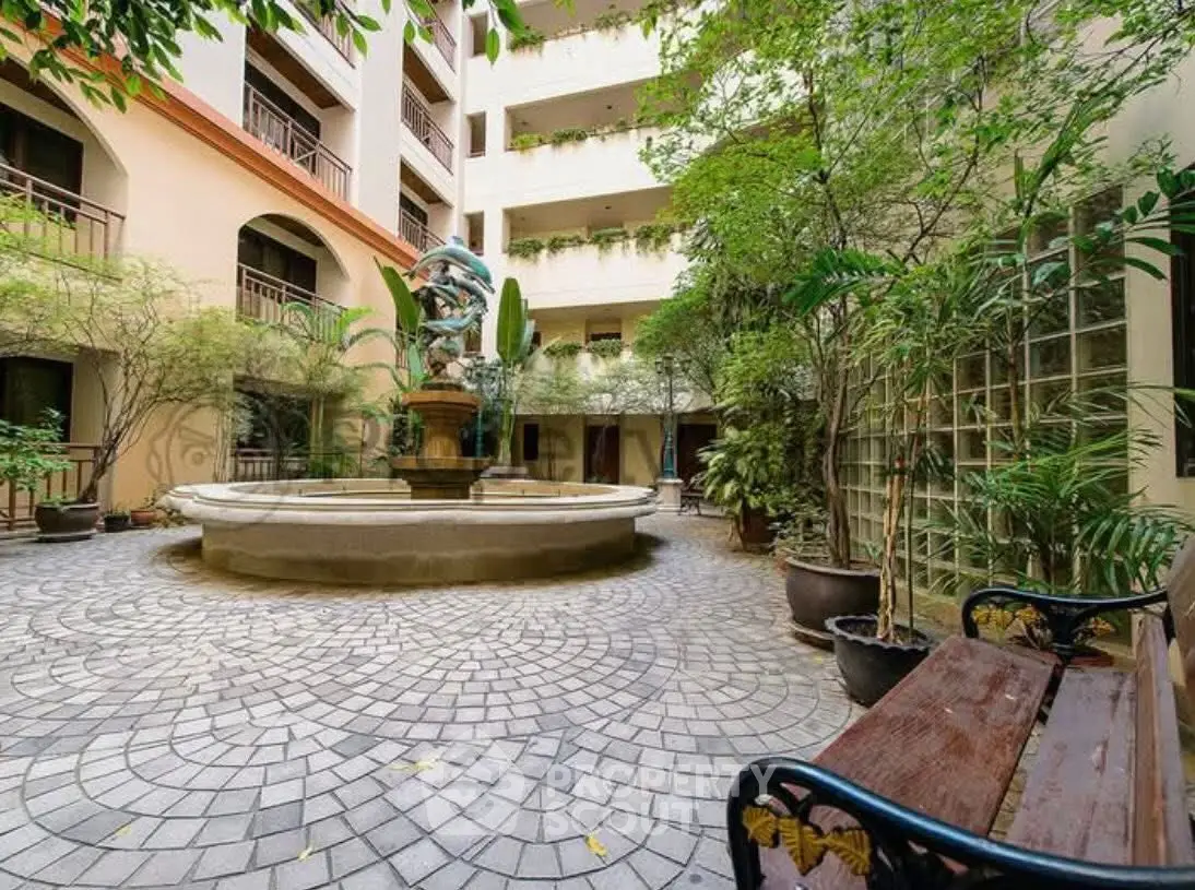 Charming courtyard with fountain and lush greenery in residential building