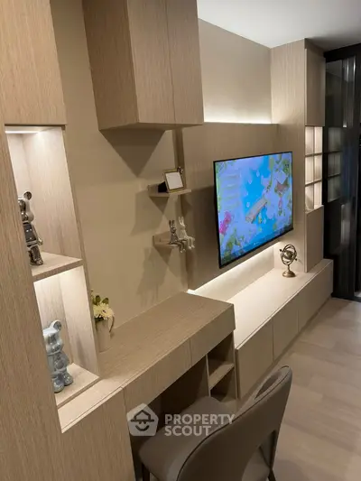 Modern living room with sleek wooden cabinetry and wall-mounted TV