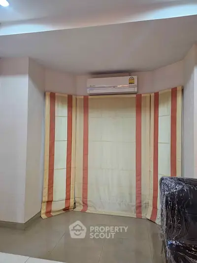 Modern living room with air conditioning and stylish curtains, perfect for comfortable living.