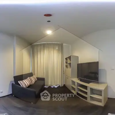 Modern living room with sleek furniture and large TV, perfect for relaxation.