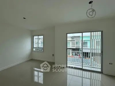 Spacious modern living room with large windows and sleek tile flooring