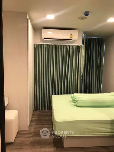 Cozy bedroom with modern air conditioning and stylish green curtains