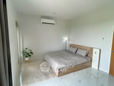 Modern bedroom with minimalist decor and air conditioning in a stylish apartment.