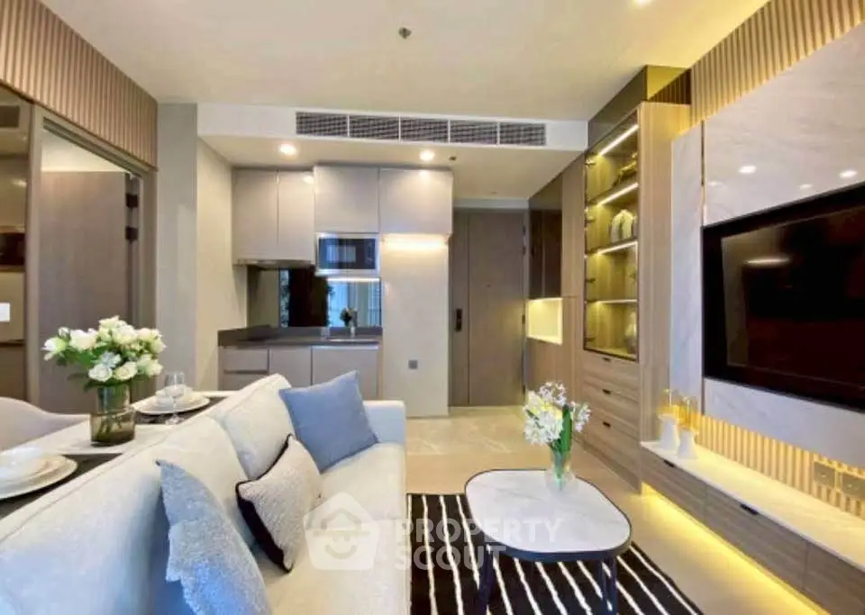 Modern living room with stylish decor and open kitchen layout in luxury apartment.