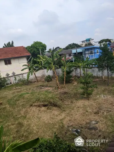 Spacious residential plot with lush greenery and potential for development in a serene neighborhood.