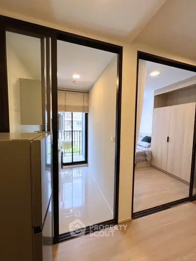 Modern apartment interior with sleek design and natural light, featuring a cozy bedroom and stylish hallway.