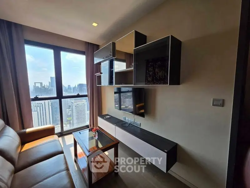 Modern living room with stunning city view and sleek wall-mounted entertainment unit.