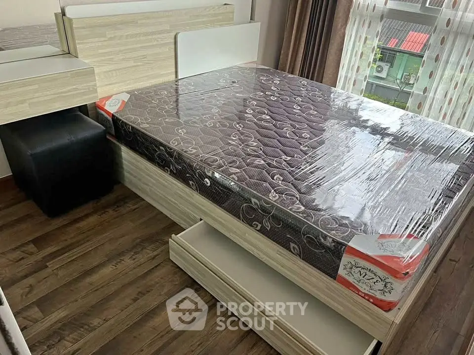 Modern bedroom with new mattress and stylish wooden flooring