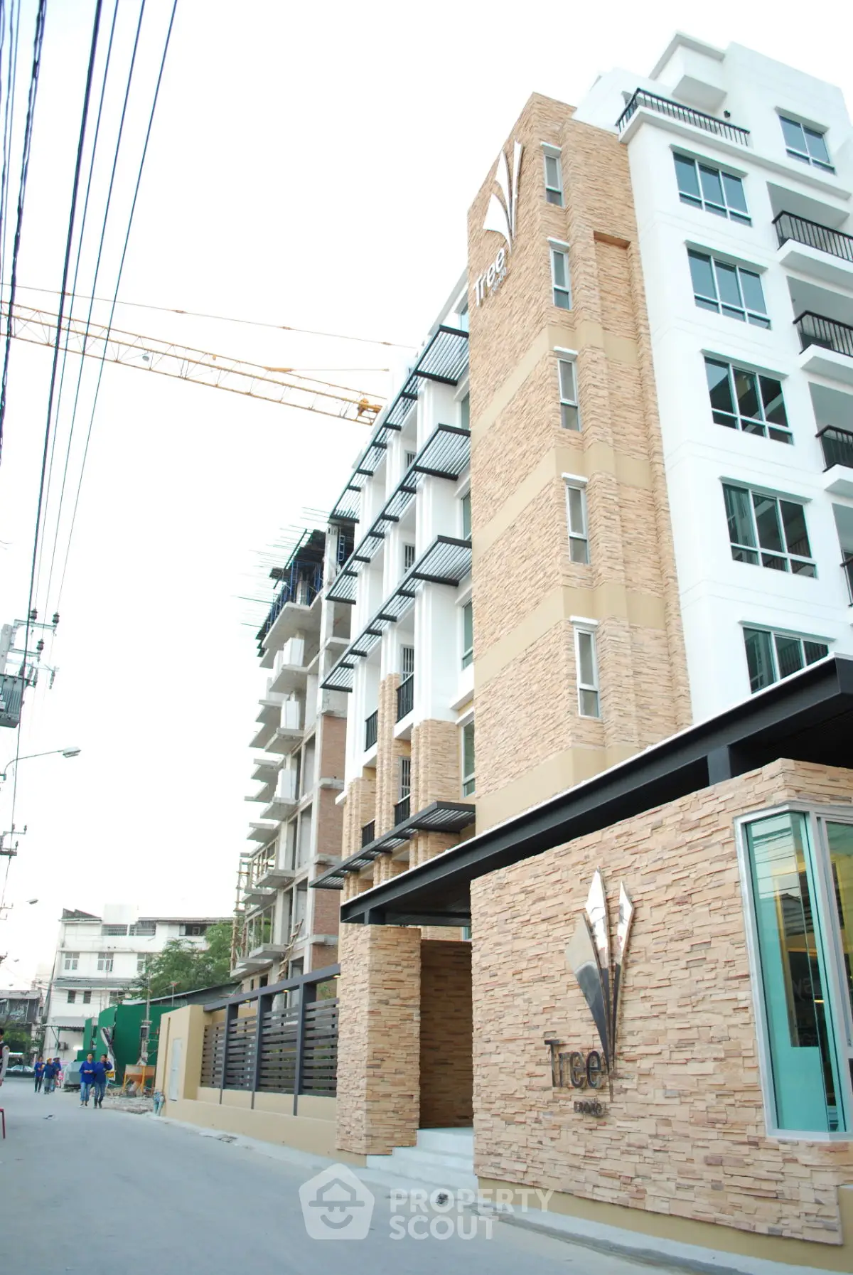 Modern residential building with stone facade and contemporary design.