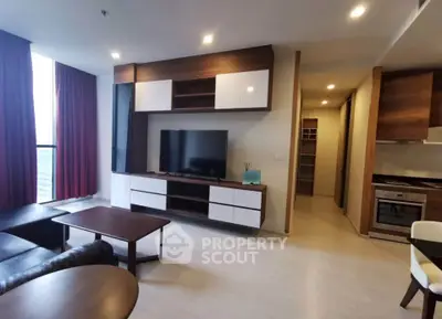 Modern living room with sleek furniture and open kitchen layout