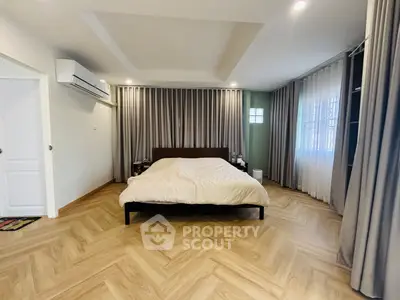 Spacious bedroom with elegant wood flooring and modern design