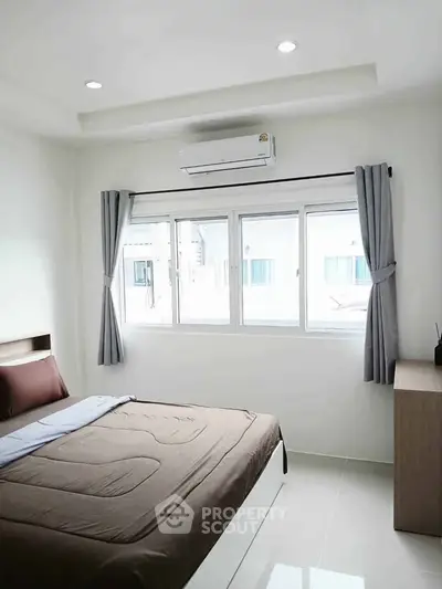 Modern bedroom with large window and air conditioning in a bright, minimalist design.