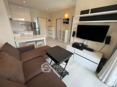 Modern living room with sleek furniture and open kitchen layout