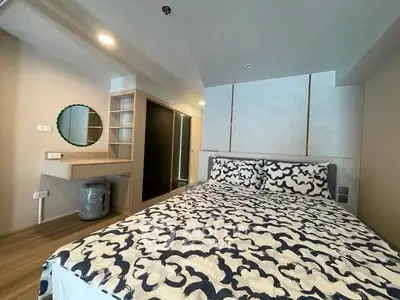 Modern bedroom with stylish decor and built-in storage in a contemporary apartment.