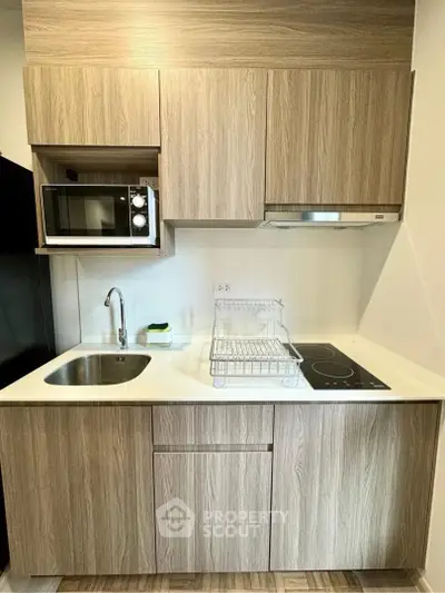 Modern kitchen with sleek wooden cabinets and built-in appliances