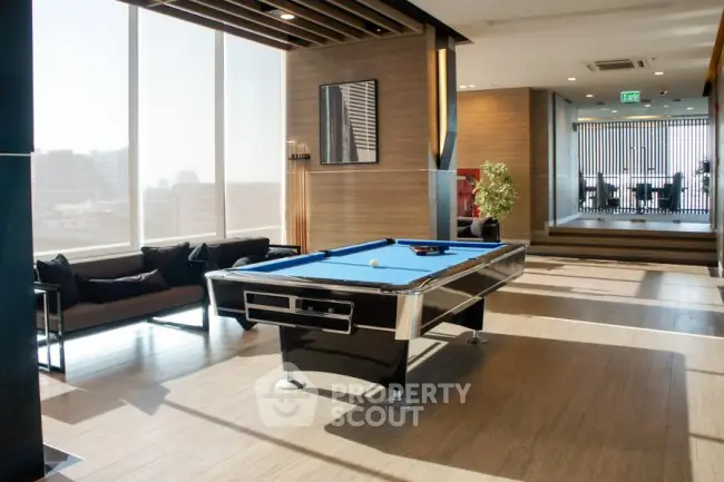 Luxurious modern living room with pool table and city view, perfect for entertainment and relaxation.
