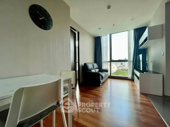 Modern living room with wooden flooring and large window view