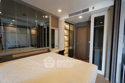 Modern bedroom with mirrored wall and built-in storage