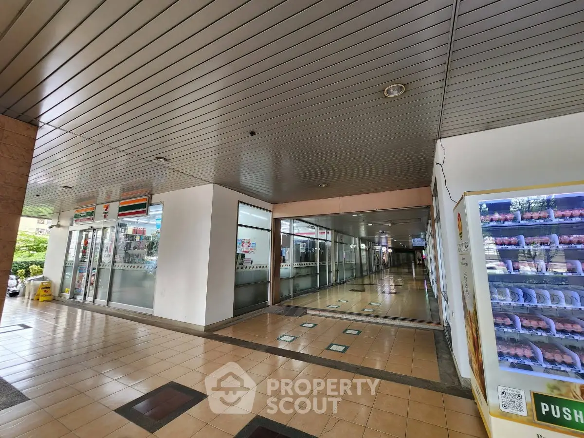 Spacious commercial building entrance with tiled flooring and glass doors