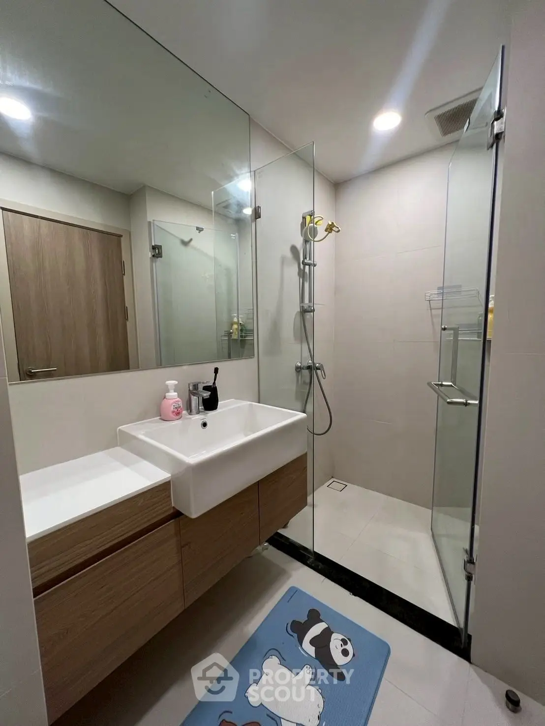 Modern bathroom with glass shower and stylish vanity