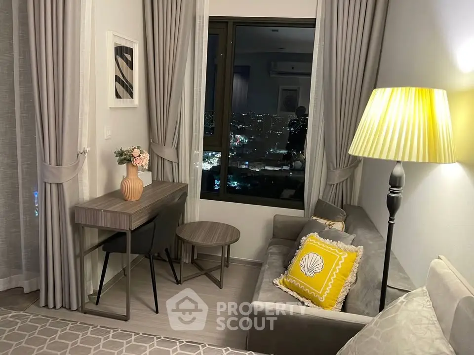 Cozy living room with city view, elegant decor, and ambient lighting.