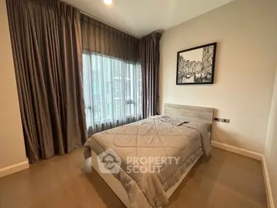 Cozy bedroom with modern decor and large window in stylish apartment