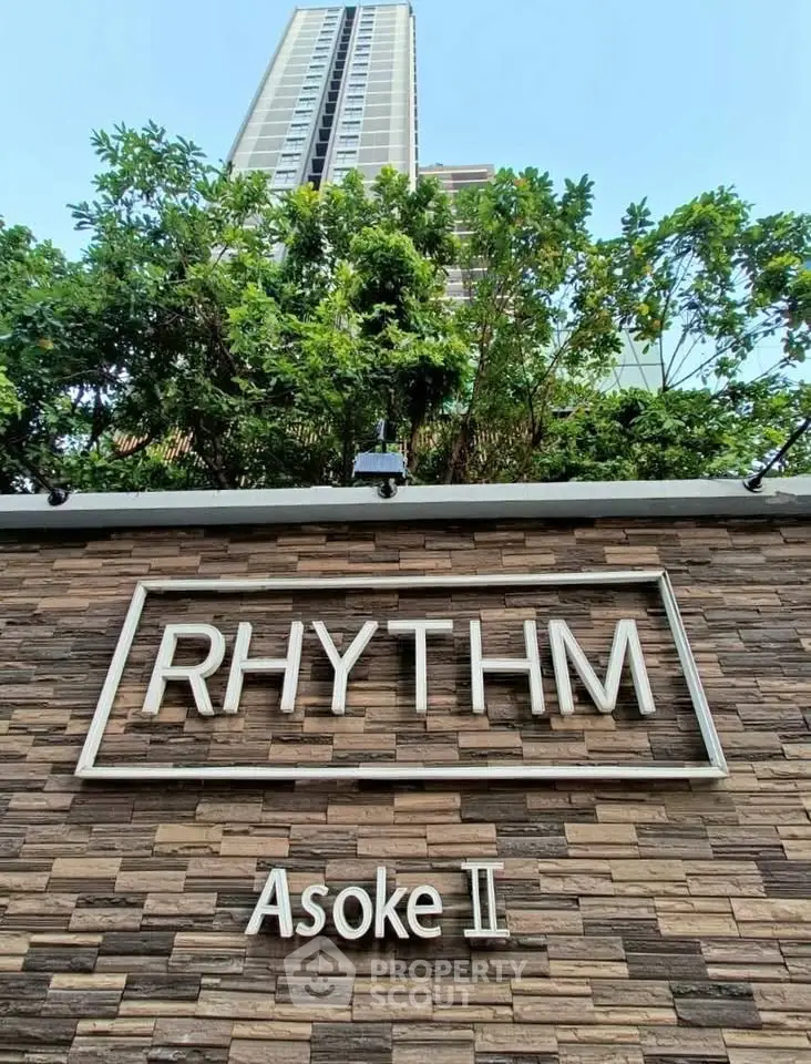 Modern high-rise building with lush greenery at Rhythm Asoke II.
