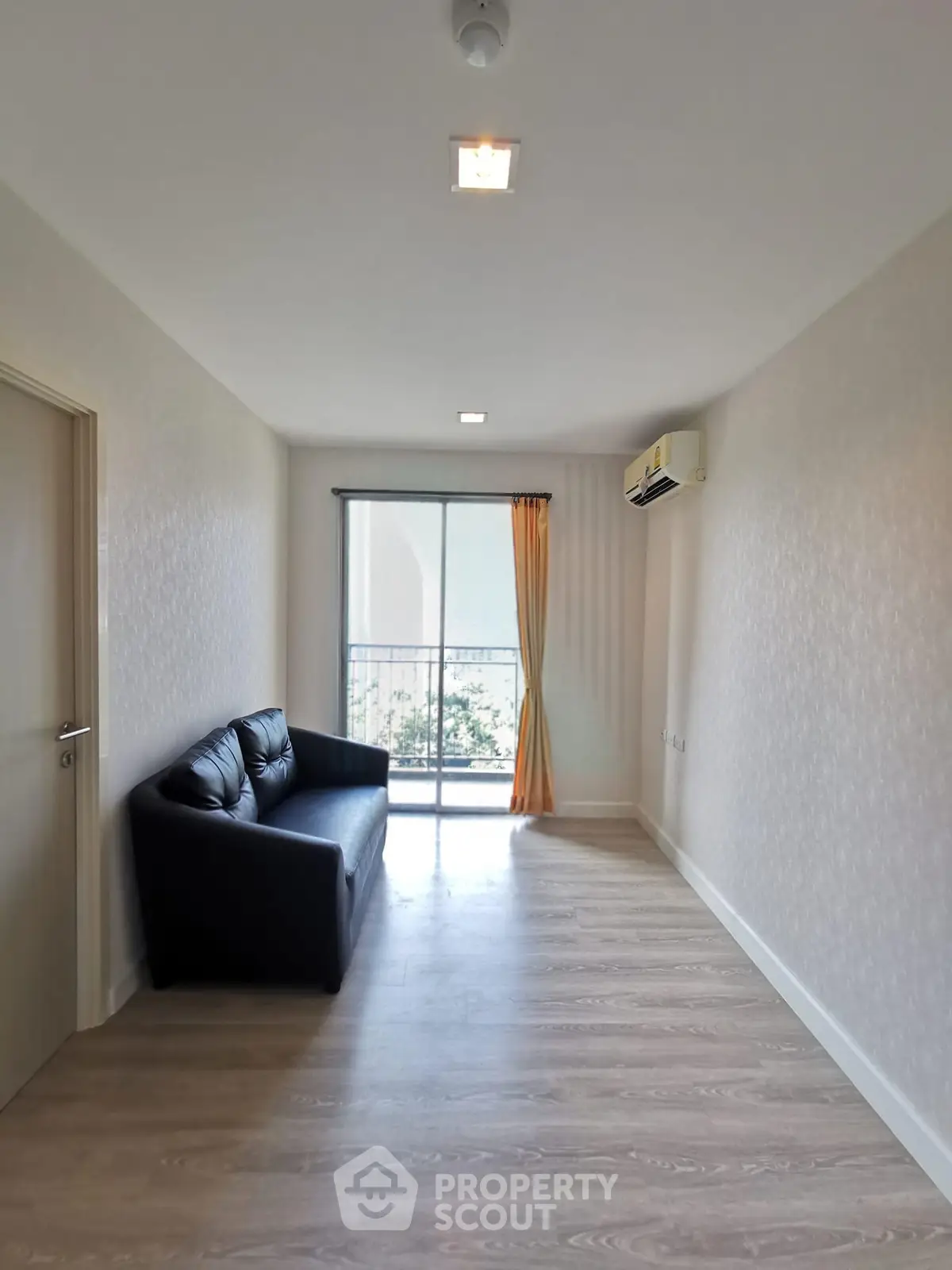 Spacious living room with balcony and modern decor in a bright apartment