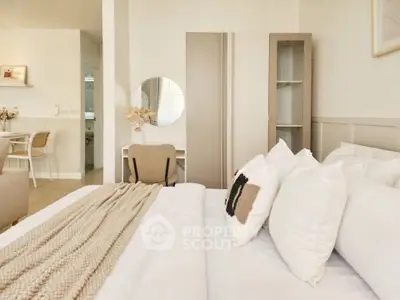 Modern bedroom with cozy decor and neutral tones, featuring a stylish wardrobe and a comfortable bed.