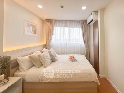 Cozy and bright bedroom with modern decor and large window view.